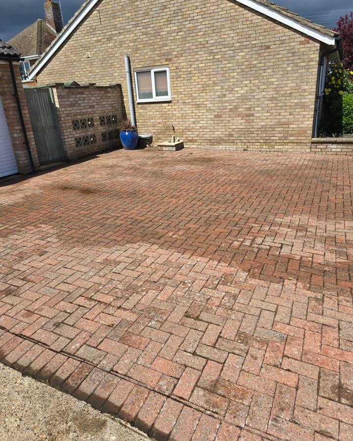 Driveway part way through cleaning, showing the cleaned and uncleaned areas side by side